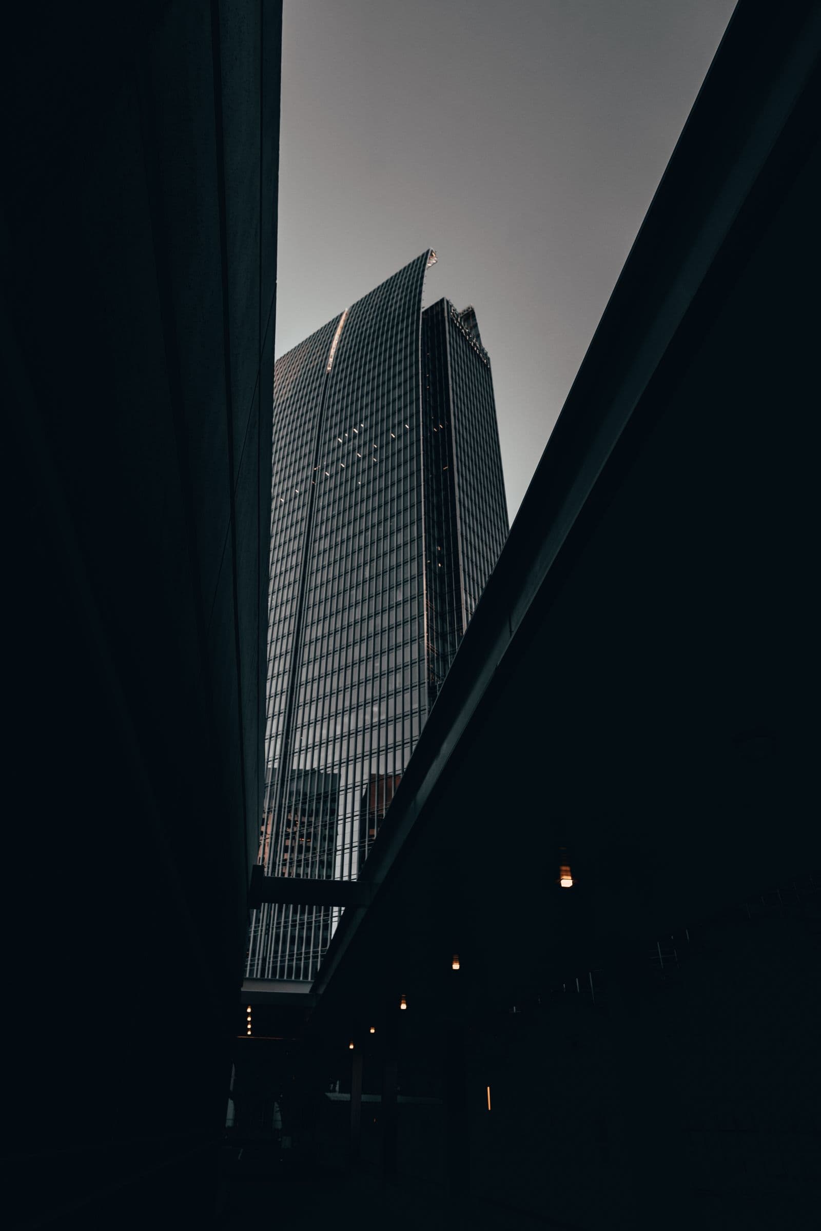 Steel and glass tower facade at dusk — premium architecture by Reliable ArCon, construction company in Lahore, Pakistan